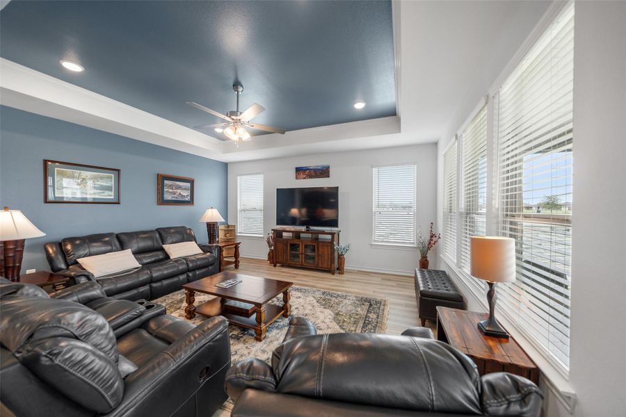 The kitchen is open to the living space, which has plenty of room for recliners and multiple sofas. Note the tray ceiling - also a usb port is located behind the television.