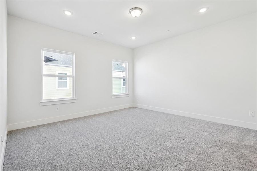 This room features light-colored walls and grey carpet flooring