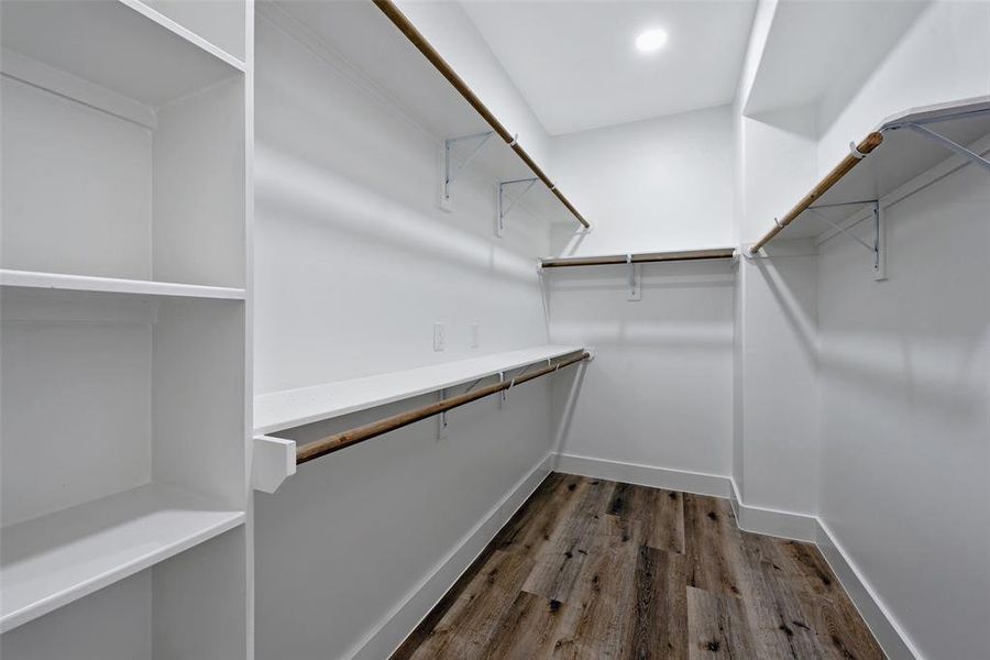 The second closet in the primary bathroom has lots of built-ins for your many clothes, shoes, and bags. The closet is designed with overhead shelves for additional storage space.