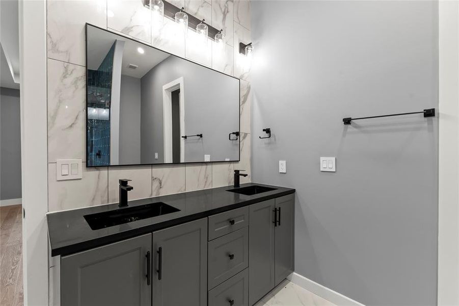 Dual Sink Vanity, Modern finishes, tile backsplash and flooring.