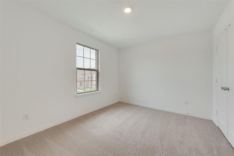 Spare room with light colored carpet