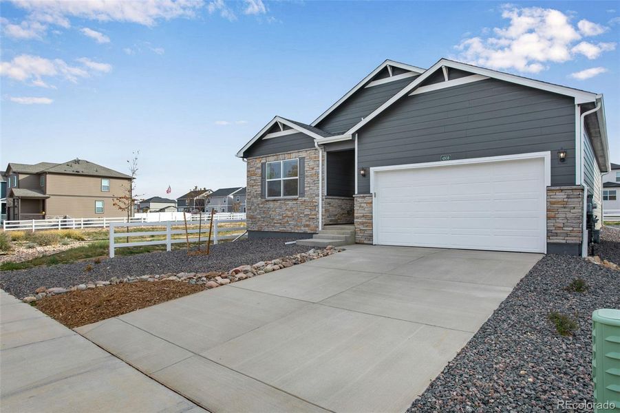 Front exterior of a new home in Ridge at Johnstown, Johnstown, CO, highlighting curb appeal (Image 20).