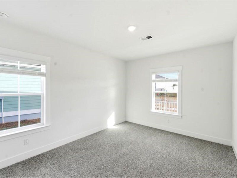 Spacious, unfurnished interior of a new home in The Coves at Lakes of Cane Bay II, Summerville (Image 37).