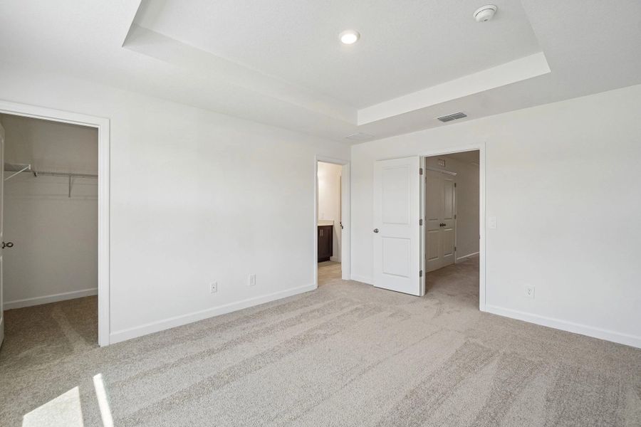 The primary bedroom has a separate walk-in closet and bathroom