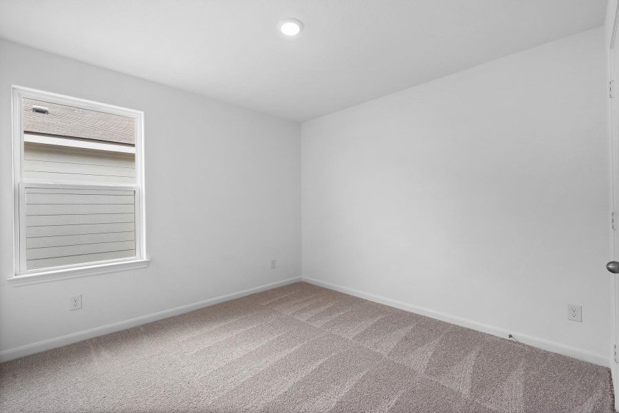 Carpeted spare room with baseboards