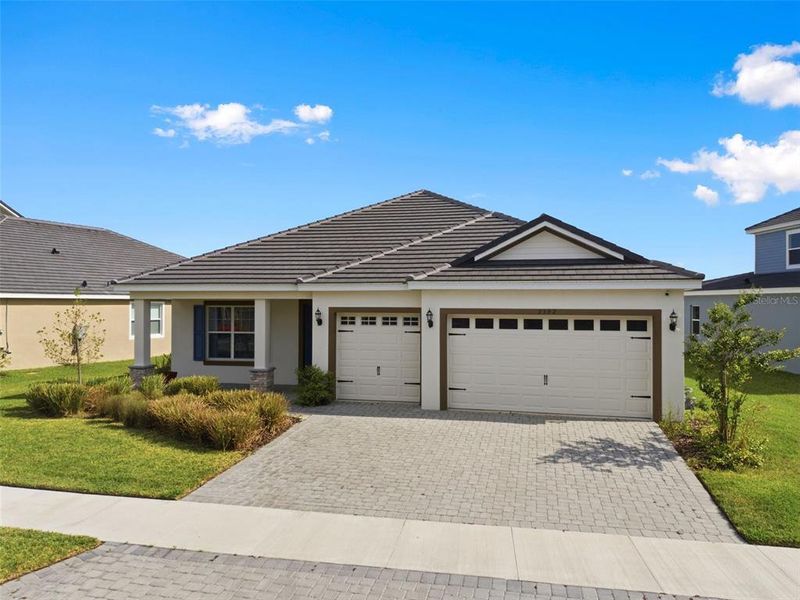 Front exterior of a new home in Tamarack at Two Rivers, Zephyrhills, FL, highlighting curb appeal (Image 25).