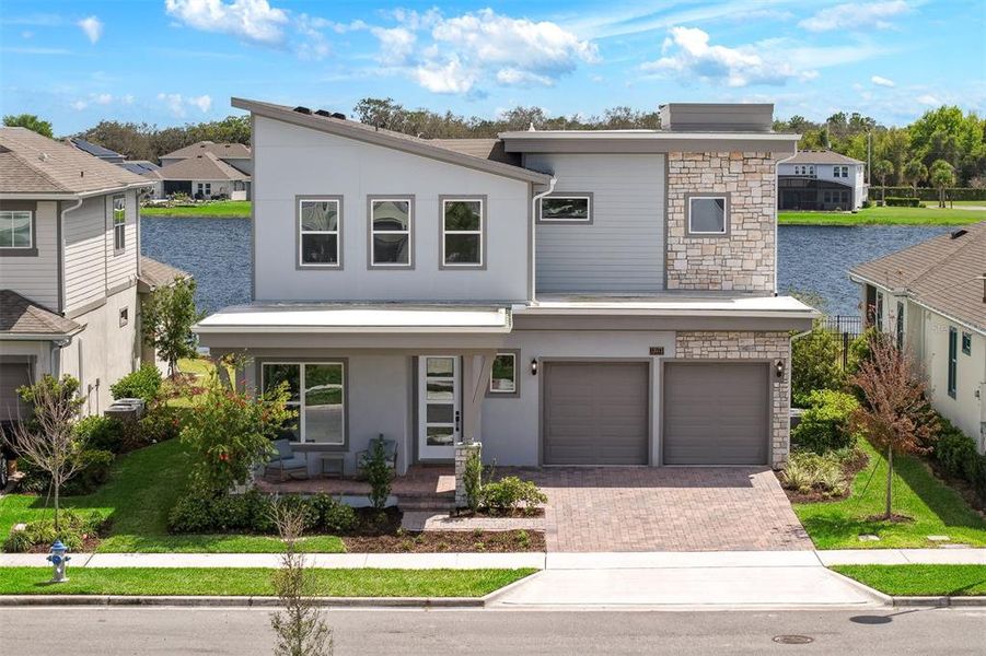 Front exterior of a new home in Laureate Park, Orlando, FL, highlighting curb appeal (Image 25).
