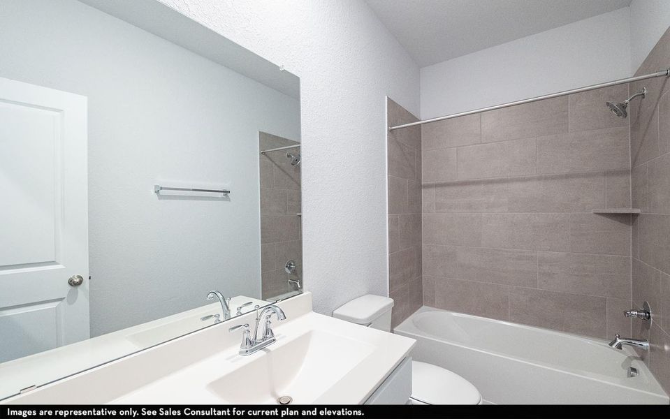 Secondary bathroom showcasing a clean modern vanity, large mirror, and tub and shower combination, providing both style and functionality for daily routines. **Photos are representative only and may vary as built.** Secondary bathroom showcasing a clean modern vanity, large mirror, and tub and shower combination, providing both style and functionality for daily routines. **Photos are representative only and may vary as built.**