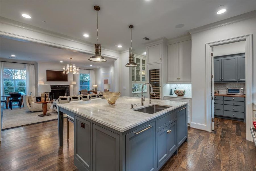 The well appointed pantry has built-in cabinets and a built in Wolfe microwave