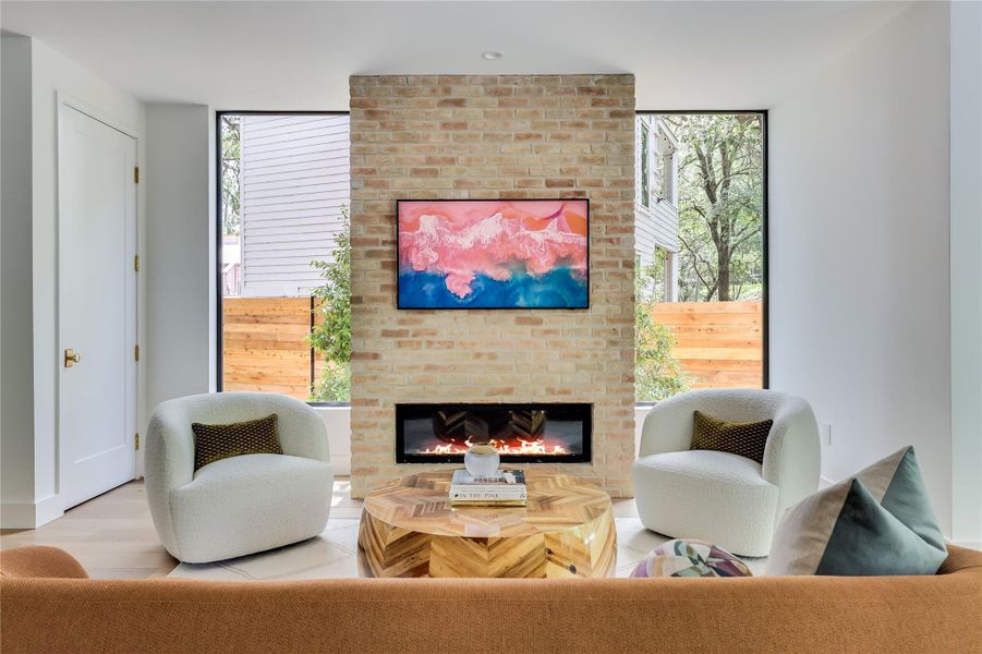 Exposed brick fireplace with a built-in linear electric fireplace