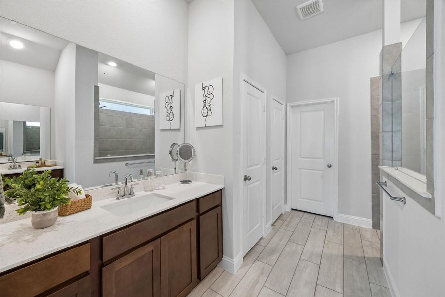 Spa-like primary bathroom equipped with a dual vanity and excellent storage. Spa-like primary bathroom equipped with a dual vanity and excellent storage.