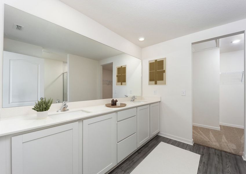 The master bathroom includes a stunning dual sink vanity and walk-in closet