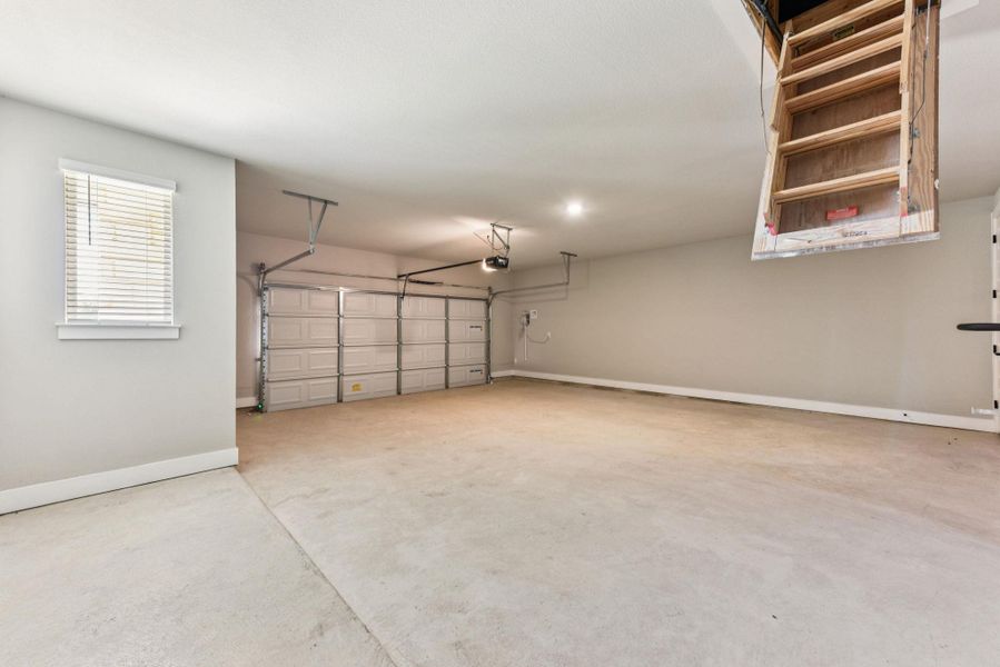 Garage featuring baseboards