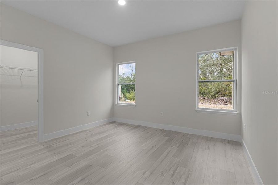 Primary bedroom with walk-in closet