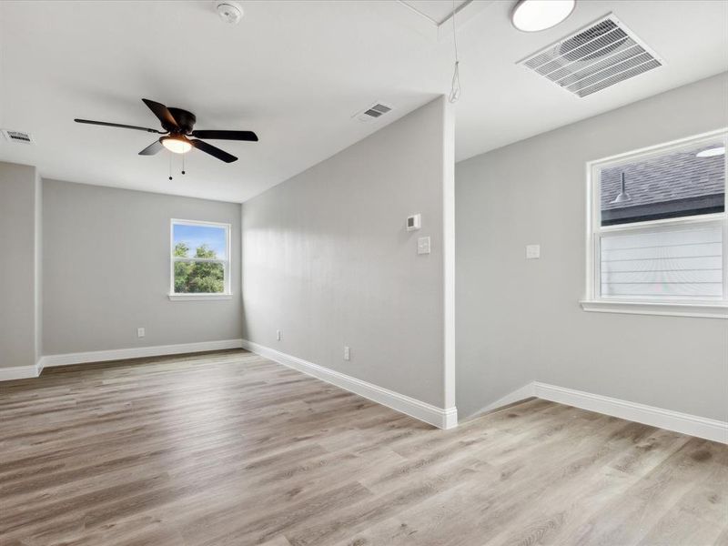 Spare room featuring ceiling fan and light hardwood / wood-style flooring