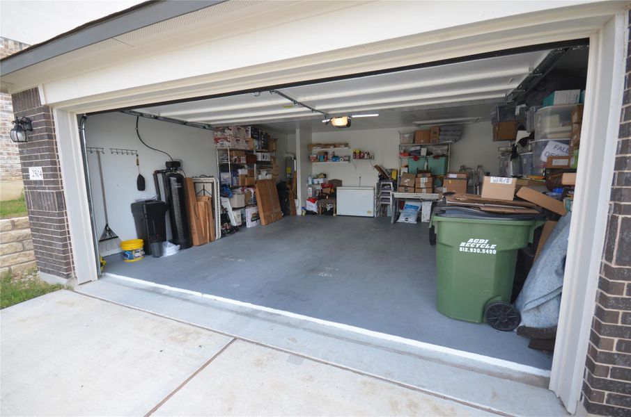 Garage featuring concrete driveway Garage featuring concrete driveway