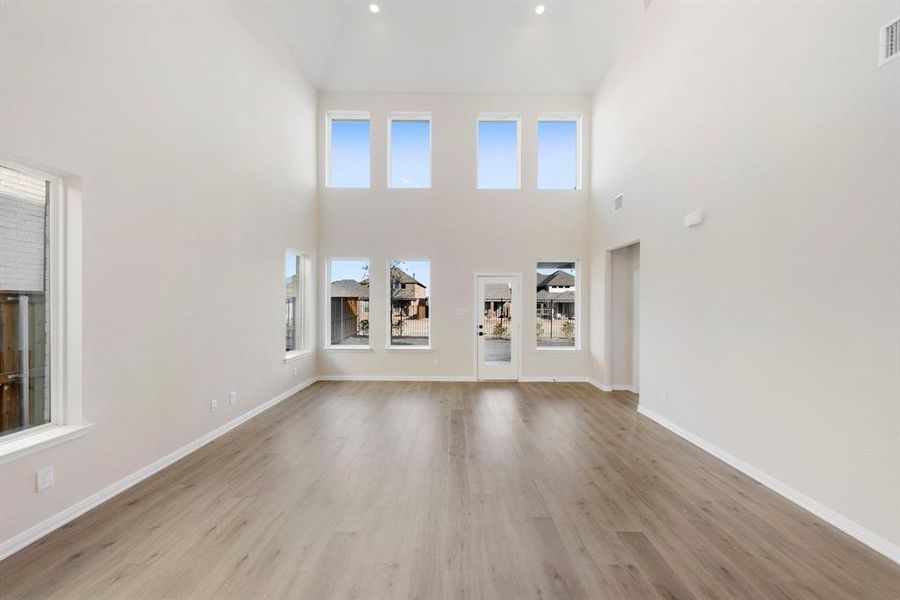 Your spacious new family room is flooded with natural light from a dual stacked wall of windows!