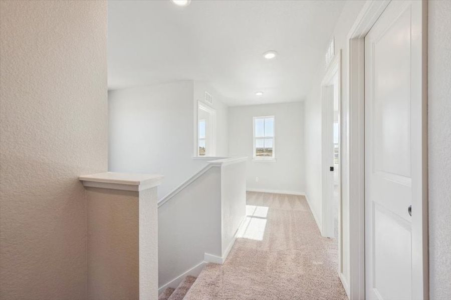 A hallway with white doors.