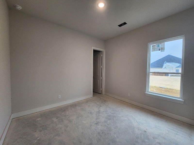 Spare room featuring baseboards and recessed lighting