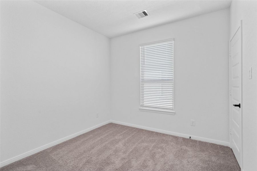 This secondary bedroom offers comfort and style with plush carpeting, neutral paint tones, recessed lighting, a large window with blinds, and a generously sized closet This secondary bedroom offers comfort and style with plush carpeting, neutral paint tones, recessed lighting, a large window with blinds, and a generously sized closet
