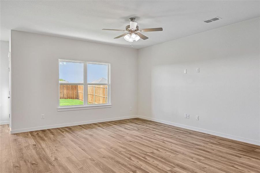 Unfurnished room with ceiling fan and light hardwood / wood-style floors