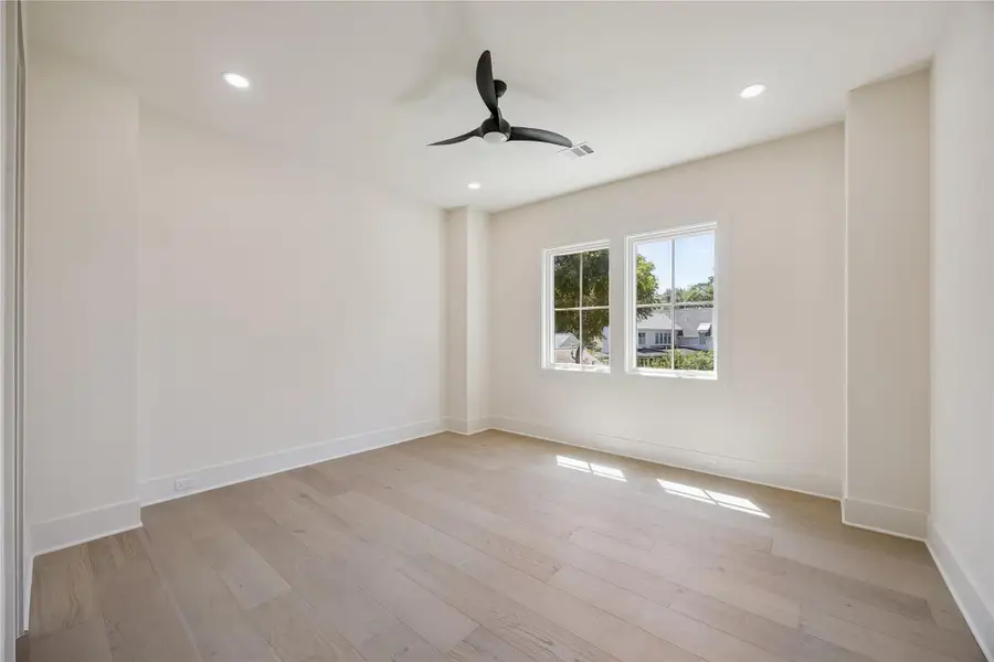 BEDROOM: Spacious secondary bedroom with hardwood floors, oversized windows, and a generous walk-in closet.