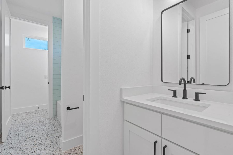 Full bath with dark aggregate flooring and vanity Full bath with dark aggregate flooring and vanity