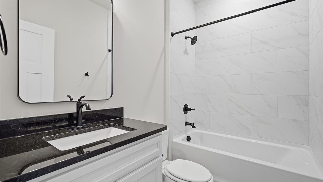 First-rate full bath featuring tiled shower, modern surfaces and a fresh, current color palette
