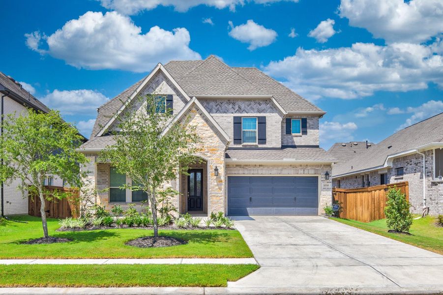 Front exterior of a new home in Dunham Pointe - Enclave Collection, Cypress, TX, highlighting curb appeal (Image 25).