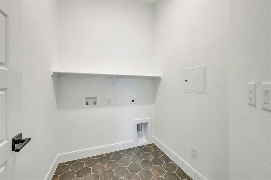 Dedicated laundry area with hexagon tile flooring