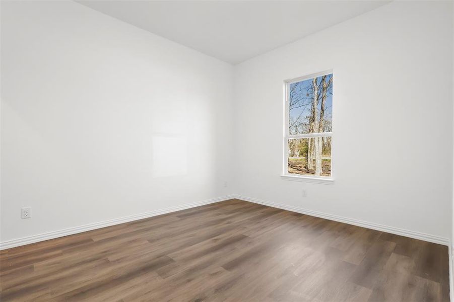 Spare room with dark hardwood / wood-style flooring