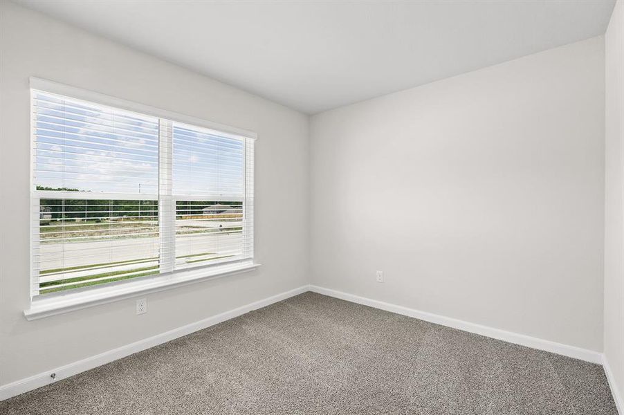 Carpeted empty room with baseboards