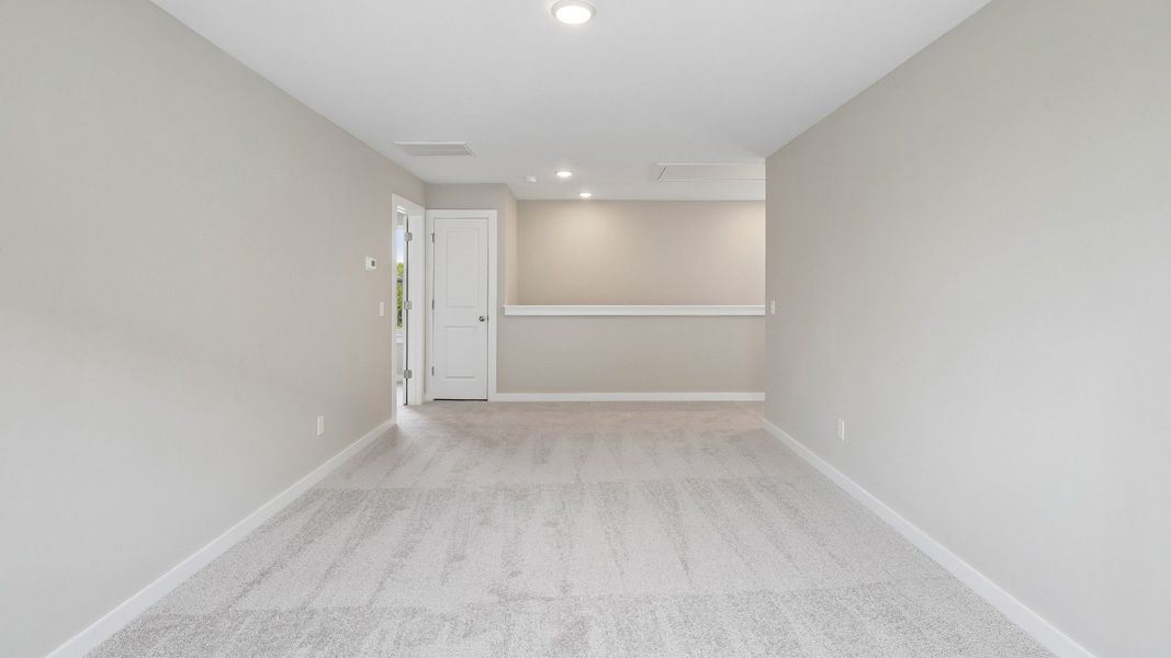 Second Floor Loft area with windows and carpet