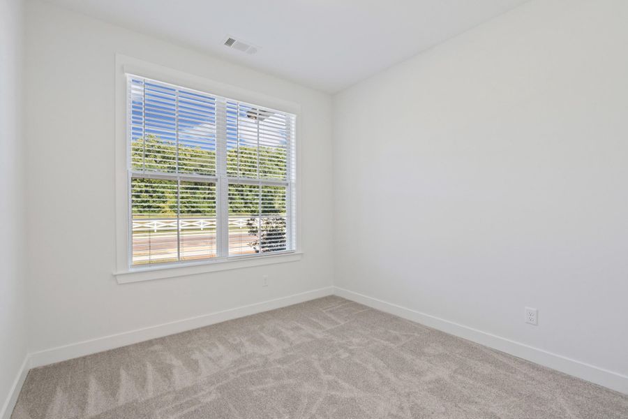 Neutral carpeting, white wall paint, and a window with horizontal blinds Neutral carpeting, white wall paint, and a window with horizontal blinds
