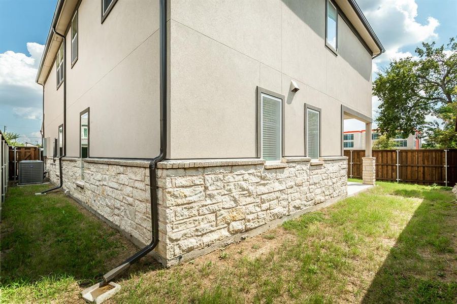 View of home's exterior with stone siding and stucco siding