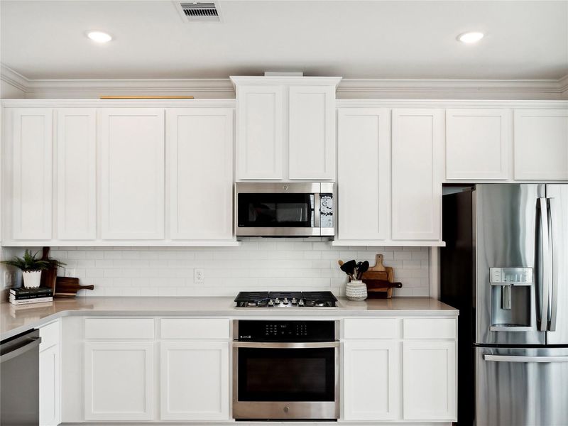 White cabinets and quarts countertops (*Photo not of actual home and used for illustration purposes only.)