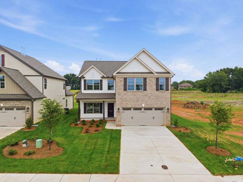 Front exterior of a new home in Sullivans Reserve, Walkertown, NC, highlighting curb appeal (Image 1). Front exterior of a new home in Sullivans Reserve, Walkertown, NC, highlighting curb appeal (Image 1).