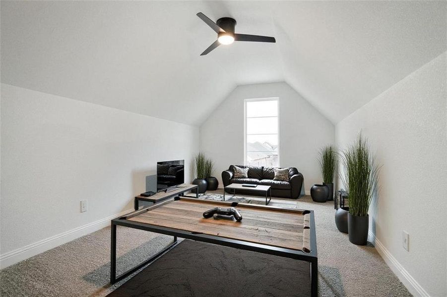 Home office featuring carpet flooring, lofted ceiling, and ceiling fan