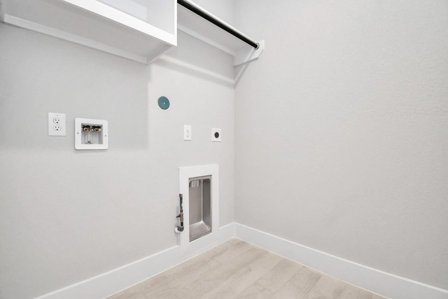 A perfect blend of functionality and comfort. Capture the essence of easy living with a first-floor laundry room, thoughtfully equipped with shelving for effortless organization. Both electric and gas connections available. A perfect blend of functionality and comfort. Capture the essence of easy living with a first-floor laundry room, thoughtfully equipped with shelving for effortless organization. Both electric and gas connections available.