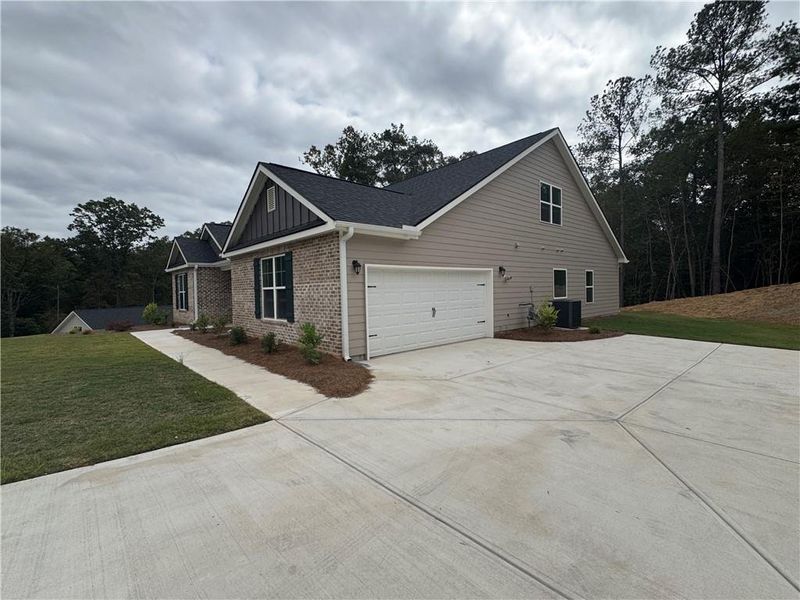 Front exterior of a new home in Tuscany Hills, Douglasville, GA, highlighting curb appeal (Image 1).