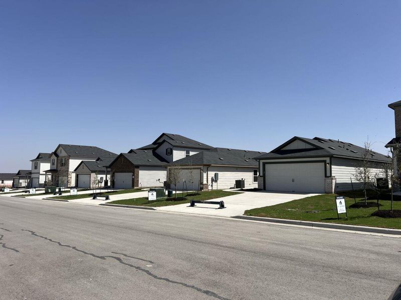 Front exterior of a new home in Cool Water, Jarrell, TX, highlighting curb appeal (Image 1). Front exterior of a new home in Cool Water, Jarrell, TX, highlighting curb appeal (Image 1).