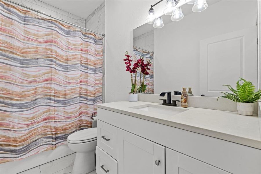 Bathroom featuring vanity and toilet