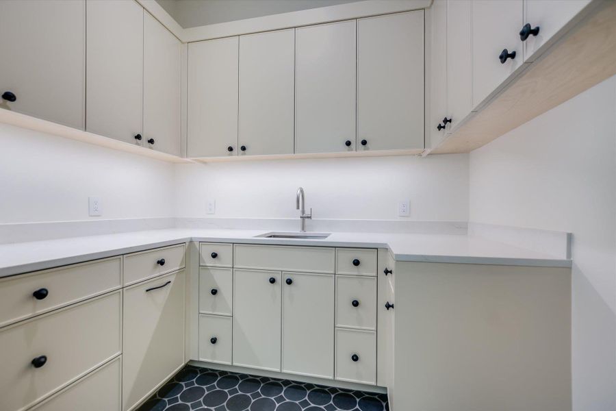 Ample storage and counter space define this practical laundry room.
