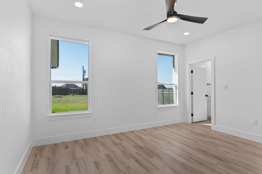 Unfurnished room featuring light wood-style floors, ceiling fan, and recessed lighting Unfurnished room featuring light wood-style floors, ceiling fan, and recessed lighting