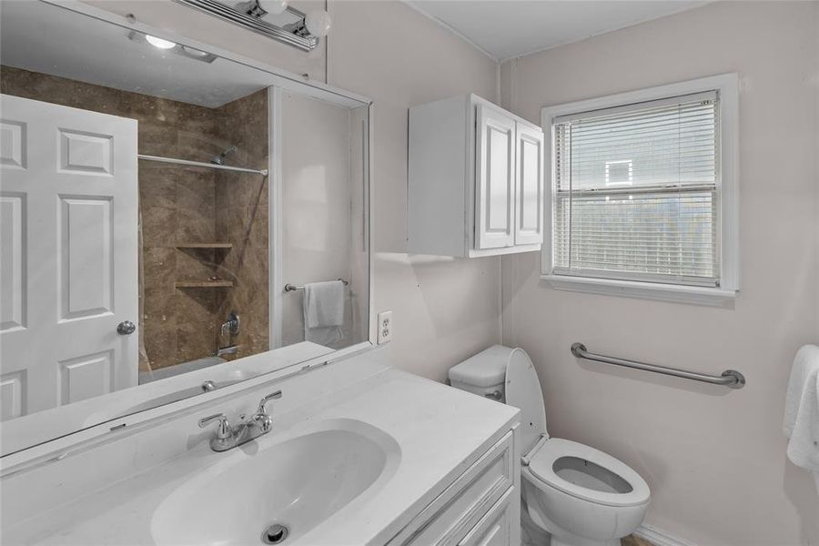 Full bathroom with vanity, tub / shower combination, and toilet