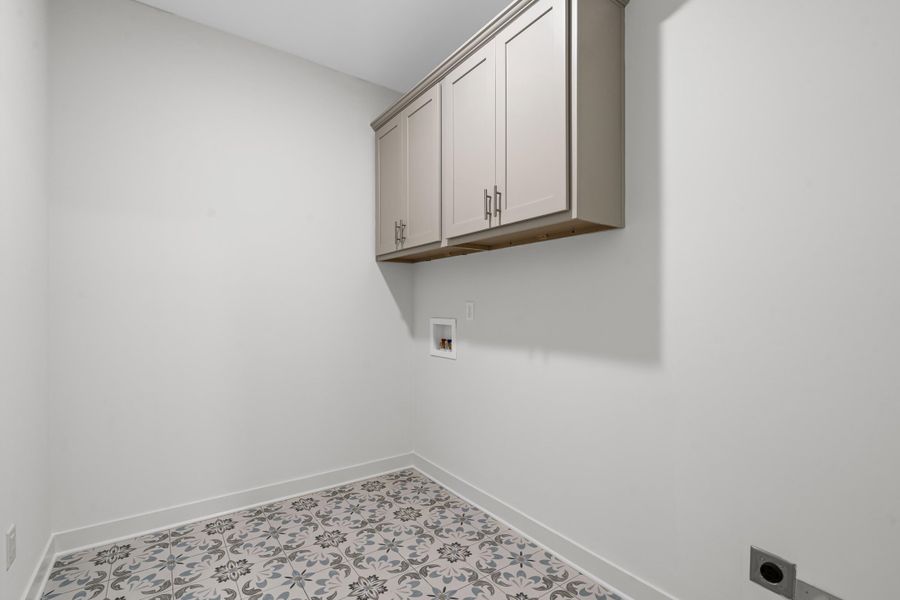 Washroom with cabinet space, electric dryer hookup, and hookup for a washing machine