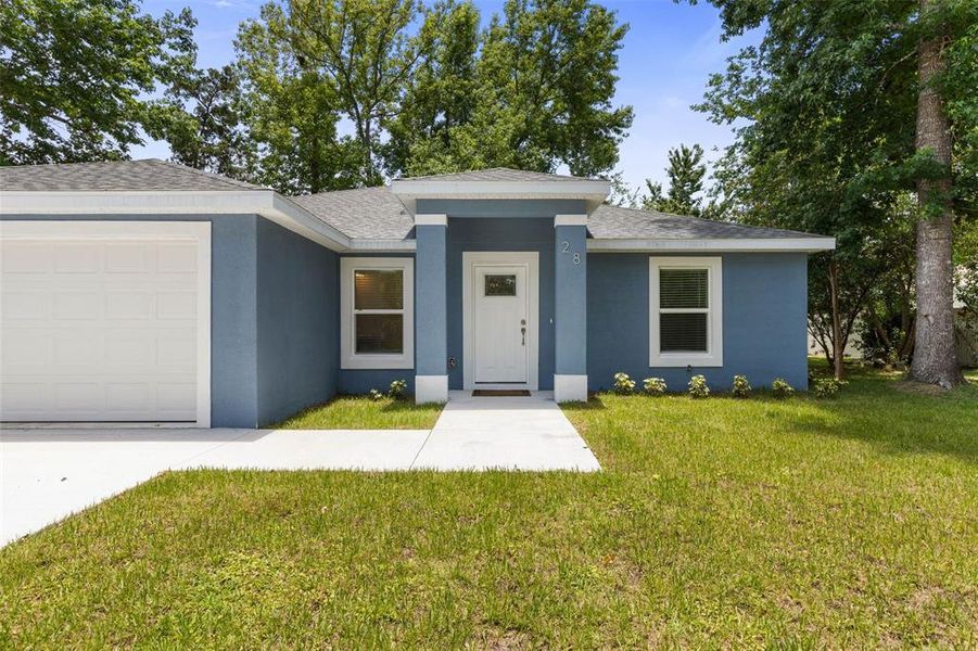 Front exterior of a new home in , Palm Coast, FL, highlighting curb appeal (Image 2). Front exterior of a new home in , Palm Coast, FL, highlighting curb appeal (Image 2).