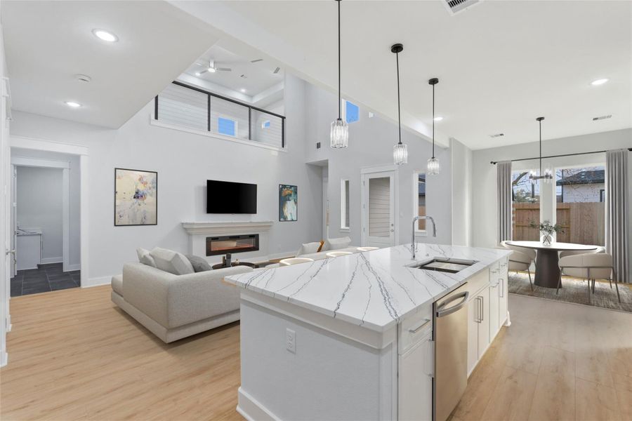 High ceilings, recessed lighting, and a pendant lit island overlooking the living area, great for entertaining and daily living. (virtual staging)
