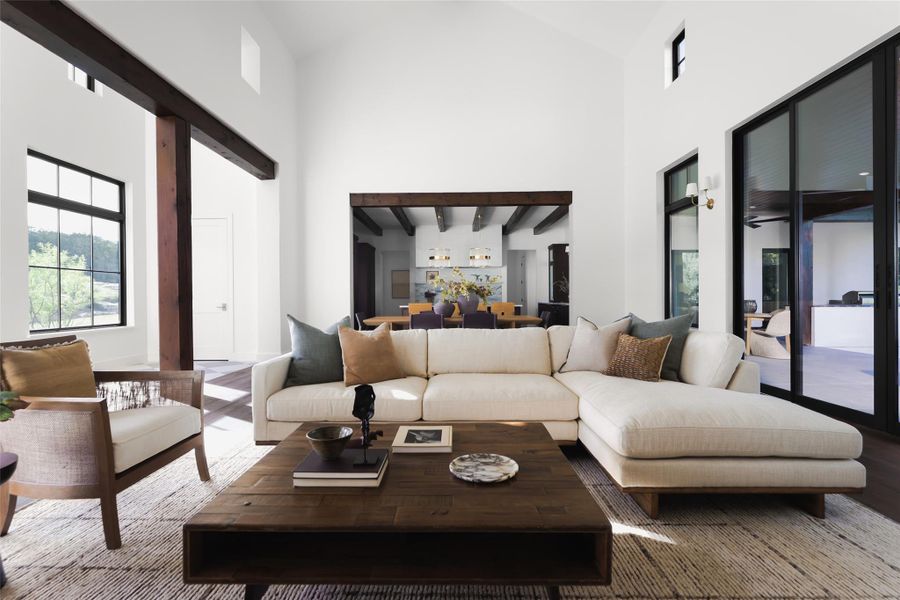 Designed for effortless hosting. Looking back from the living area, you can see how the space opens directly to the chef’s kitchen. This layout is ideal for those who want to stay part of the conversation at the large center island while relaxing in the main living space.