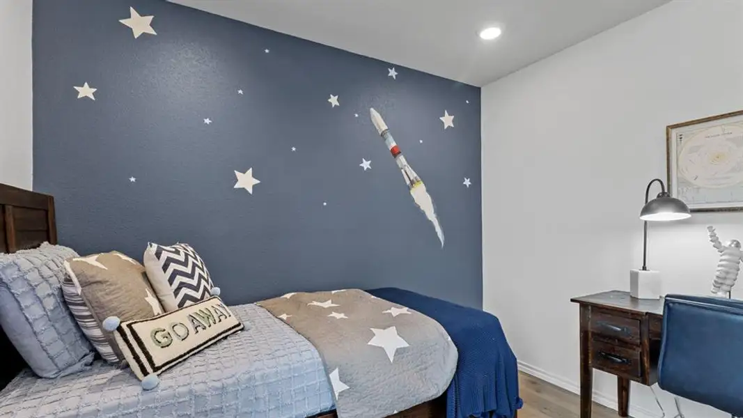 Bedroom featuring an accent wall, wood finished floors, and recessed lighting Bedroom featuring an accent wall, wood finished floors, and recessed lighting